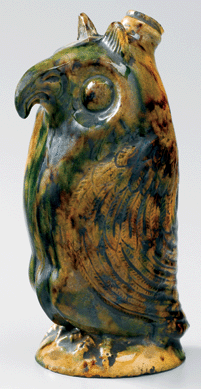 The Salem owl bottle is 7¼ inches tall and appears to be spectacled. The figure has a tortoiseshell glaze and is only one of four known Moravian owl figural bottles.