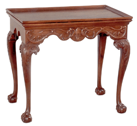 Top lot of the sale was this rare Philadelphia Chippendale mahogany tea table, circa 1770, featuring a rectangular tray top over a frame with applied carving supported by curved cabriole legs terminating in ball and claw feet. It went to a collector in the room for $76,050. 