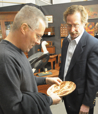 Greg Kramer shows a customer a rare Shenandoah Valley redware plate.