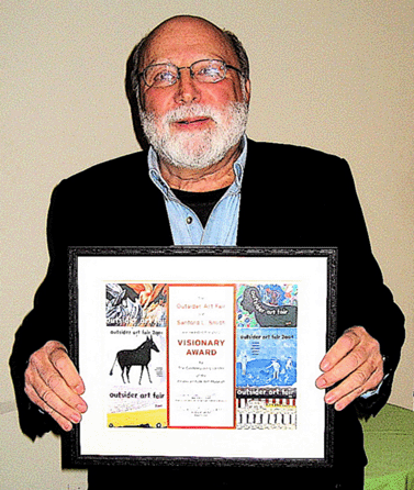 Sandy Smith is shown with his award. The Folk Art Museum has been a beneficiary of more than 40 of Smith's arts and antiques shows over the years.