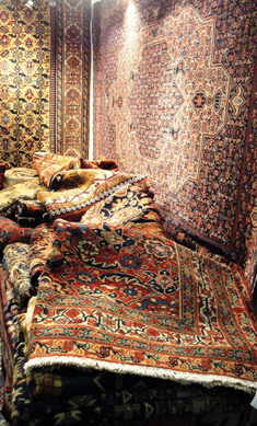 The booth of Fardin's Oriental Rugs, Fairfield, Conn., showcased Nineteenth Century Oriental rugs. The navy rug on one wall is a Seneh from Persia, 1880, measuring 4 by 6 feet, and the one in front is Farahan from Persia, 1870, also 4 by 6 feet.