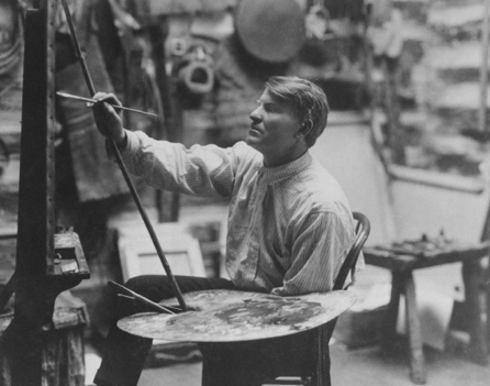 Russell's rugged good looks are apparent in this view, painting in his studio. His home, studio and a museum housing his works are open to the public in Great Falls, Mont.
