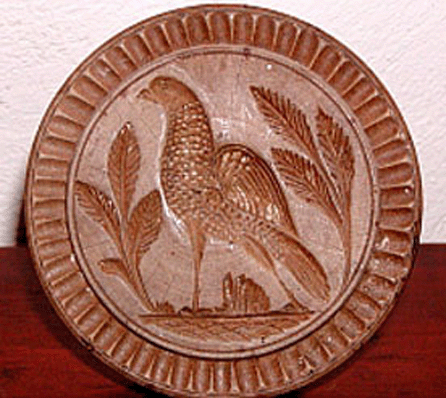 One of three butter prints reported stolen from an exhibitor's booth at the Holliston Antiques Show was this carved partridge standing amid foliage with a fluted border, an applied handle and measuring approximately 3¾ inches in diameter.