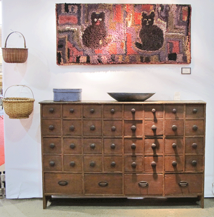 "Cats,†hung above a 36-drawer apothecary from a dry goods store in Springfield, Mass., circa 1850‶0, at Emele's Antiques, Dublin, Penn.