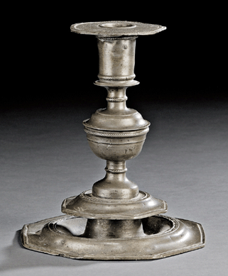 A Seventeenth Century English pewter candlestick with a plate rim base, an octagonal bobeche and rope and foliate decoration fetched $10,073.