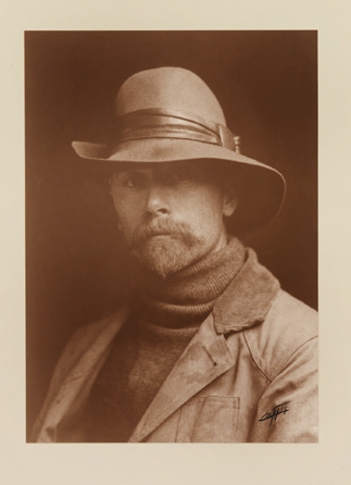 Famed photographer of Indians of the West, Edward S. Curtis looks positively jaunty in hat, turtleneck sweater and beard in an 1899 self-portrait. His 20-volume series, The North American Indian, published 1907‱930, featured selections from his 40,000 images of Native Americans. National Portrait Gallery.