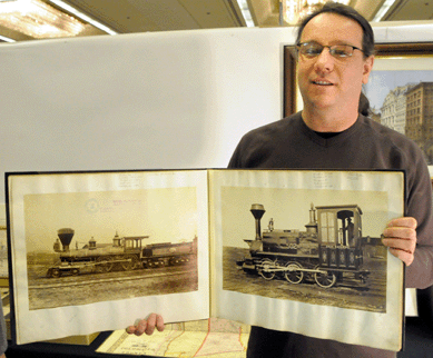 James Arsenault with an oblong folio filled with locomotive photographs from Brooks Locomotive Works, 1870s, Dunkirk, N.Y. James Arsenault & Co., Arrowsic, Maine