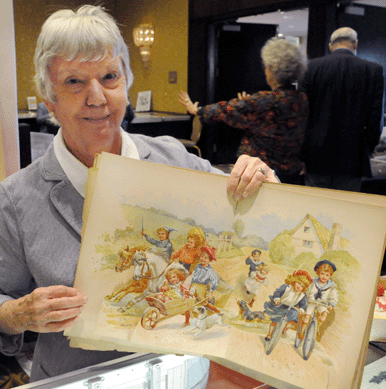 Jean Kulp with a 1890 "Nister†popup children's book. Jean's Books, Hatfield, Mass.