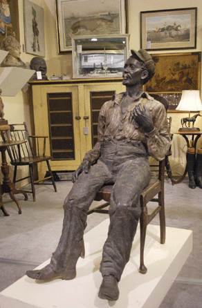 A life-size terracotta figure of a stevedore, attributed to Bernhard Bloch and shown at the Paris Exposition in 1900, was an attention-grabber at Stevens Antiques, Fraser, Penn.