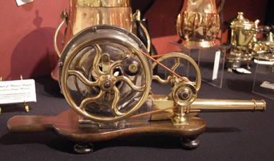 Michael J. Whitman, Fort Washington, Penn., showed this brass centrifugal hand blower or mechanical bellows on a mahogany stand with four turned feet that was English or Irish, circa 1800.