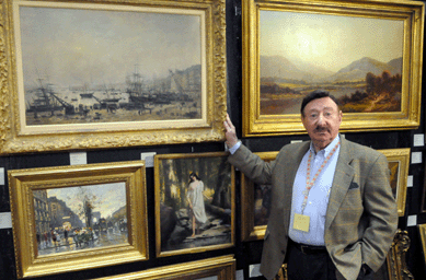 Bill Union shows off his paintings.  Art and Antiques Gallery, Worcester, Mass.