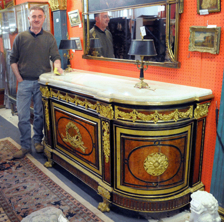 Auctioneer Ronan Clarke with the ormolu-mounted and inlaid French commode, discovered in a storage unit housing the New Jersey estate, that sold for $64,625. 