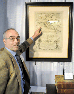 Tom McLaughlin with a copper engraving with an original hand coloring by Sebastian Bauman of "The Battle of Yorktown†printed in Philadelphia, 1782. Donald A. Heald Rare Books, New York City