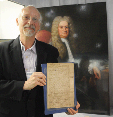 David Waxman holds a manuscript autographed by Isaac Newton. Estates of Mind, Great Neck, N.Y.