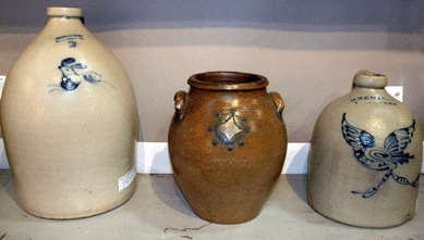 Local clay accounts for the darker hue of the center jar, a 1790 New York 1-gallon ovoid form, attributed to David Morgan of New York City, according to dealer Ron Bassin, A Bird in Hand Antiques, Florham Park, N.J. Left is a 2-gallon Norton rabbit jug, Burlington, Vt., circa 1847‵0, and right is a 1-gallon jug stamped "Wm. E Warmer,†West Troy, N.Y., circa 1829‵2, depicting a spread winged eagle carrying a banner in its beak..