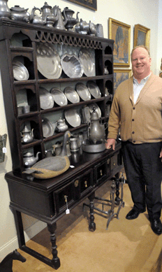 Auctioneer Colin Stair with a selection of merchandise from the collection.