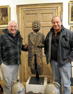 George Barimo, left, and Ben Schechter with a carved and painted wood ship's figurehead of an African American gentleman which hammered down at $2,330.