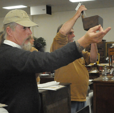 Auctioneer Joseph Kabe works the crowd.