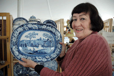 Dora Connolly of Antiques Folly, Emmitsburg, Md., shows an historical blue transfer ware platter in the Wild Rose pattern, circa 1840s.