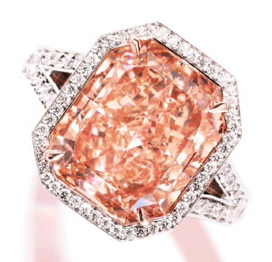 Fancy intense pinkish-orange diamond ring, set with a 7.67-carat, type IIa, cut-cornered rectangular modified brilliant-cut stone that is the largest flawless or internally flawless diamond of this pinkish-orange color graded by the GIA to date, realized $3,106,500.