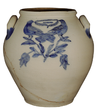 An early ovoid crock decorated with two incised and cobalt-filled birds on a flowering sprig and holding a leaf that is draped under the maker's mark, Brayton & Kellogg, Utica, N.Y.