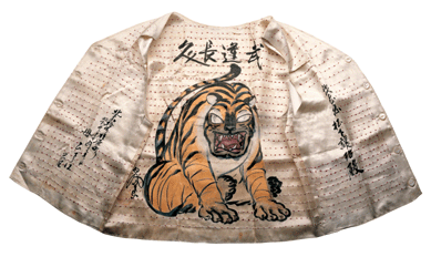 A fierce tiger, symbolizing courage, highlights this traditional Senninbari vest, created by the mother of George Matsushita, who wore it while serving with the famed 442nd Regimental Combat Team in Italy. Following custom, the vest, conceived at the Amache, Colo., camp, included 1,000 French-tied knots, each made by a different person to wish the wearer good luck and long life. Japanese American Archival Collection Library, California State University, Sacramento.