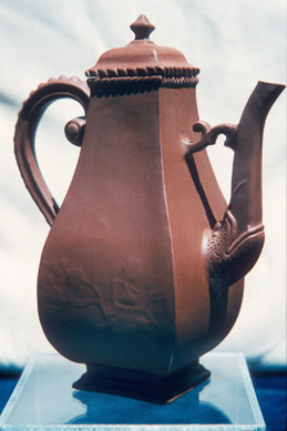 A coffeepot and cover, circa 1710‱3, is a fine example of Meissen's Böttger red stoneware with the overall shape of the piece displaying Turkish influence. Dresden court goldsmith Johann Jacob Irminger designed this coffeepot and modeled the spout after Chinese Yixing ware.