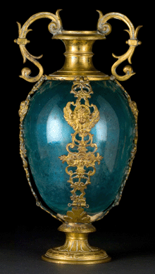 This shiny blue glass standing vase with gilded copper mounts probably originated in mid-Nineteenth Century France.