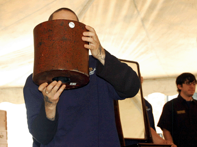 A lacquered wood brushpot, held aloft by an unidentified runner, sold for $5,750. 