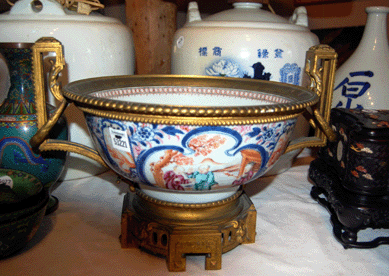 The Chinese Export centerpiece bowl with elaborate gilt-bronze mounts fetched $2,185.