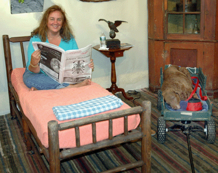 Paulette Nolan took time out to catch up on the news, while Keeper caught up on sleep in a comfortable wagon.