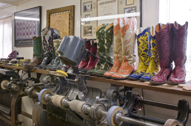 This elongated finishing machine, which dominates Deana McGuffin's garage workshop, is an integral element in her custom boot making, which also utilizes varied leathers, many spools of colored thread and considerable handwork. The finished products are wearable art.