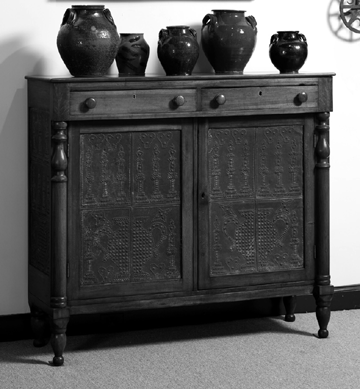 This pie safe, attributed to Christian Burgner, is in the MESDA collection. The similarities to a signed Christian Burgner safe include the applied half turnings, the applied walnut veneer panels on the corners, and the urn and candles punched tins. 