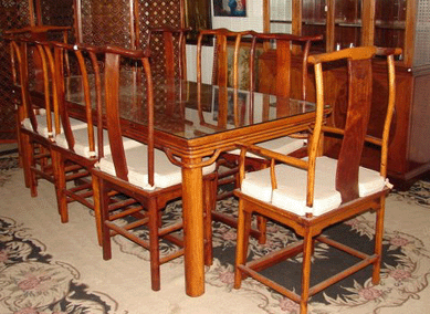 Glass-top huanghuali table, 86 inches long, with eight round leg chairs, two with arms, realized $10,800.