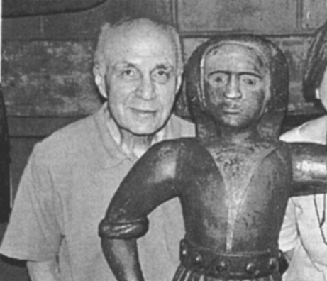 Harvey Kahn poses with one of his favorite objects before the 2002 auction of Part 1 of his collection at Northeast Auctions.