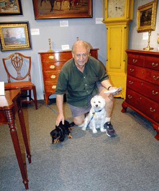 Between hanging pictures and lining up pieces of furniture, Ed Weissman found time to entertain two of his closest friends, Lilly, at left, a visitor, and Lucky, a member of the family.