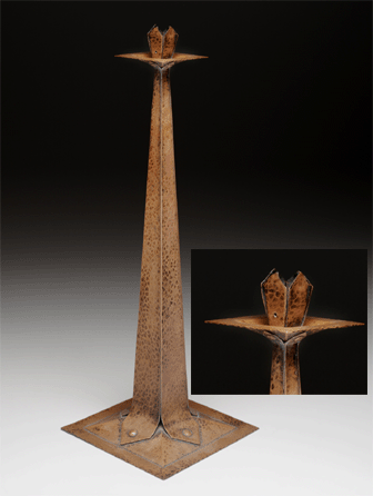 Seeking to harmonize the color of his furnishings with his furniture, Stickley's household objects, such as this copper candlestick, circa 1905, were hand-hammered to create light-catching surfaces, and given a rich warm brown patina. It is nearly 21 inches high. The estate of Dr Edgar G. McKee.