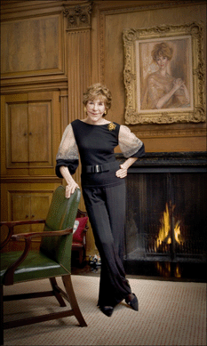 Betsy Bloomingdale at home, pictured with her portrait above the fireplace.