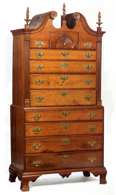 The Hazard family New England Chippendale cherry bonnet-top chest-on-chest, Rhode Island or Southeastern Massachusetts, 85 inches high and 42 inches wide, was estimated at $10/15,000; it made $21,240.