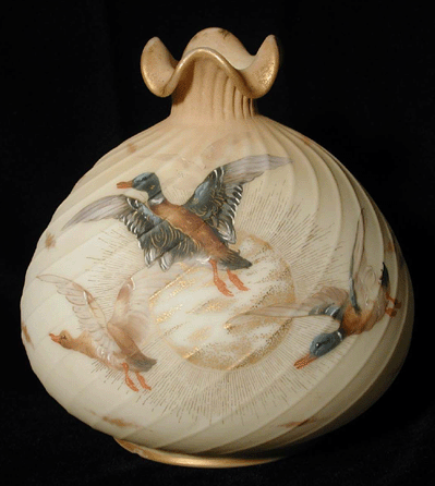 A Crown Milano vase by the Mount Washington Glass Company, circa 1895, of blown opal glass and decorated with fired enamel Guba ducks.