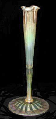 A floriform blown glass vase from Tiffany Glass and Decorating Company of Corona, N.Y., circa 1900, was made with 16 opalescent optic ribs. It is signed L.C.T. / F303. 
