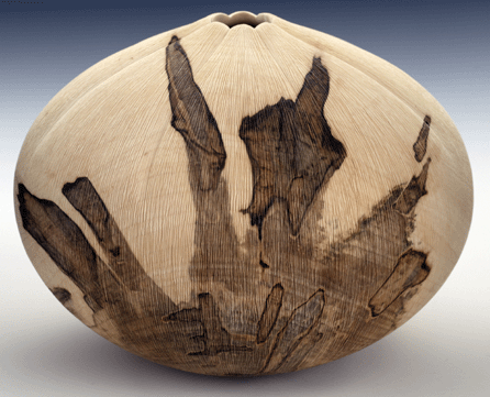 Tennessean John Jordan combined lathe turning, carving and wire brushing on red maple to create this untitled piece in 1998. It measures 9 by 7½ by 7½ inches.