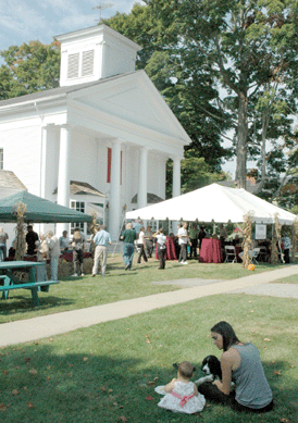 A tent, laden with food, drink and a warm welcome to those attending the open house was at the front of the shop. ⁁ntiques and The Arts Weekly photos, R.S. Smith