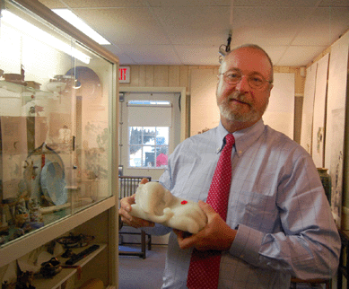 John Scofield graciously posed with the Eighteenth Century carved white jade figure of an elephant that realized $86,250. 