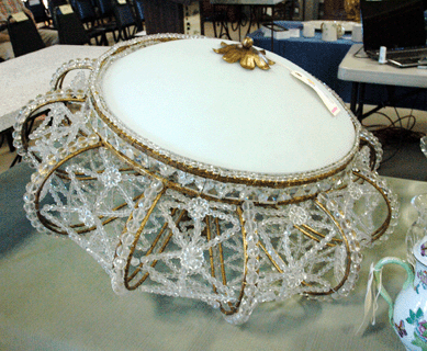 An Empire-style chandelier of gilt metal and beaded glass chandelier, circa 1920s, 30 by 17 inches, took $1,150. 