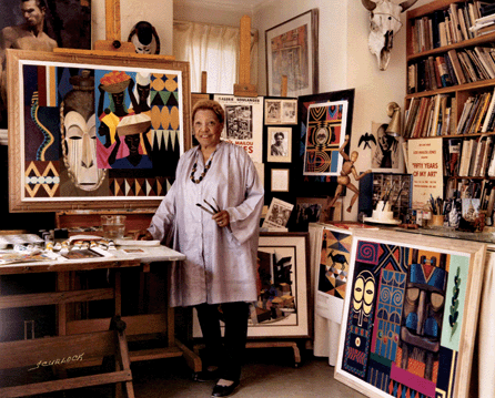 Smiling and optimistic, with three paintbrushes in hand, Jones stands in her Washington, D.C., studio, surrounded by favorite paintings and memorabilia. This 1983 photograph by Scurlock Brothers is part of the papers of Lois Mailou Jones in the Moorland-Spingarn Research Center, Howard University.