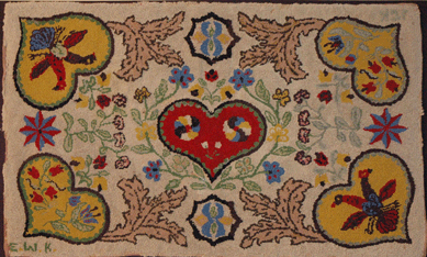 This colorful hooked rug with hearts, flowers and birds, shown by Karen and Paul Wendhiser, Ellington, Conn., featured its makers' initials "EWK†and "JCK†enclosed in two hearts in opposite corners, hinting of a sisterly collaboration.