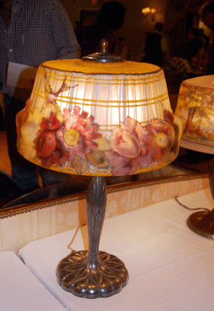 The Pairpoint puffy lamp decorated with hummingbirds and colorful flowers was signed on the base and sold for $3,895.