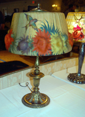 A Pairpoint puffy shade with hummingbirds amid the orange and yellow flowers realized $2,760.