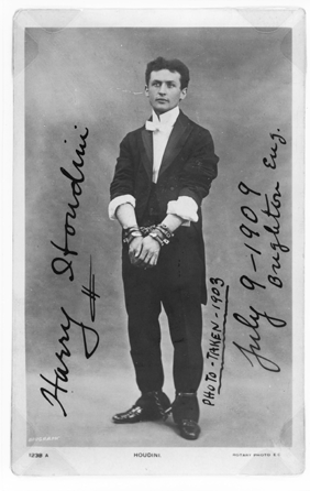 Manacled hand and foot, in this 1903 photograph Houdini is shown about the time his career took off, after he was crowned "The Handcuff King†for his ability to escape all manner of cuffs. Courtesy of Library of Congress, Rare Books and Special Collections Division, McManus Young Division.